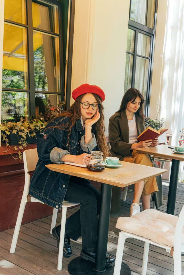 Writing Prompt ~ Writing: My Quirky Little Weight Loss Tip ~ A Woman Writing on a Notebook and a Woman Reading a Book